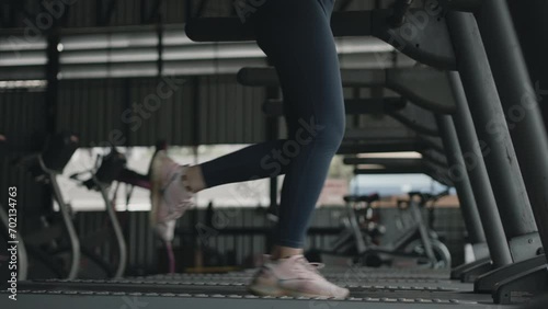 Woman running on treadmill in gym, Cycling at the Gym, Cardio and leg muscle, Building Leg Strength, Exercise for health, Warm up in the gym.