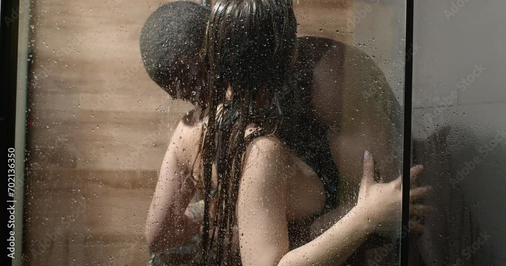 Attractive affectionate mixed race heterosexual couple in shower engaging in sexual games,african man and caucasian woman hugging, embaracing. side view copy space. love, relationships, sex, passion