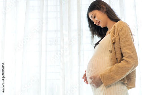 Free Download Happy smiling Mother woman hugging and smiling expecting with pregnancy hold baby in belly, woman pregnant, birth, preparation, maternity, care with childbirth at home.Love of family - GFXLoad