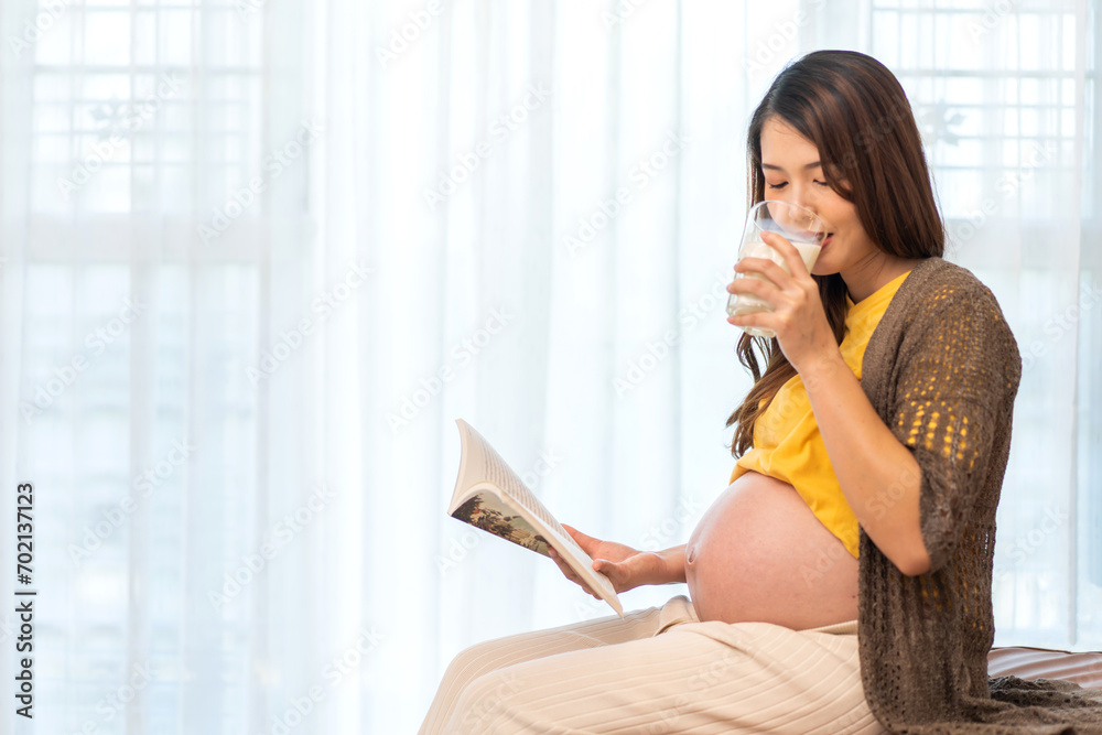 Happy smiling asian mother woman hugging and smiling expecting with pregnancy baby in belly drink milk, woman pregnant, birth, preparation, maternity, care with childbirth at home.Love of family Happy smiling asian mother woman hugging and smiling expecting with pregnancy baby in belly drink milk, woman pregnant, birth, preparation, maternity, care with childbirth at home.Love of family