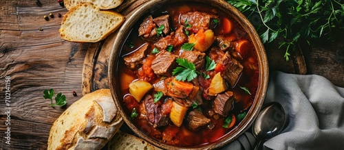 Beef stew served with crusty bread in a bowl. with copy space image. Place for adding text or design