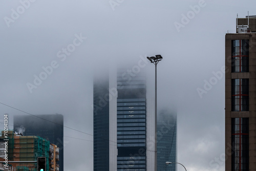 Urban landscape of modern office and apartment buildings on a rainy day in Madrid, Spain photo