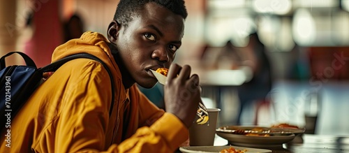 An African student having a healthy lunch. with copy space image. Place for adding text or design