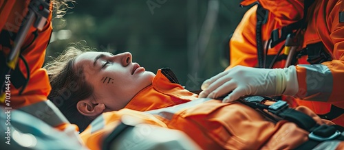 A firefighter leans over to check the pulse and breathing of a victim lying on the floor Saving people. with copy space image. Place for adding text or design