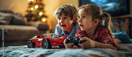 Children sit at slot machines and have fun Cheerful sister cheering on brother who drives a toy car in a video game. with copy space image. Place for adding text or design