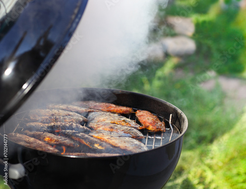 Fish fillets on the grill with flames photo