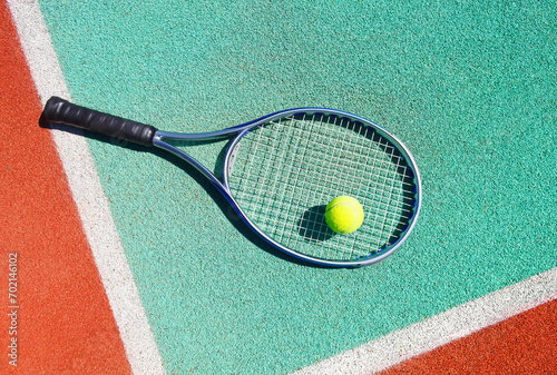 Close up of tennis racquet and ball on the tennis court © Dasha Petrenko