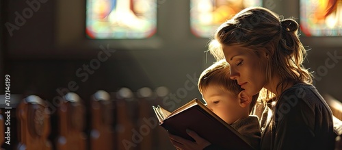 A Christian mom tells her son Bible stories about Jesus sitting in church Faith religious education modern church mother s day maternal responsibilities mother s influence on son s worldview