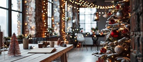 Empty startup office decorated with christmas lights and tree to celebrate winter holiday season Festive decorations and ornaments in workplace seasonal xmas decor for gifts and presents photo