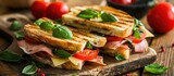 Club sandwich panini with ham tomato cheese and basil. with copy space image. Place for adding text or design