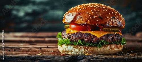 A delicious grilled Angus burger with cheese lettuce and tomato on a sesame seed bun. with copy space image. Place for adding text or design photo
