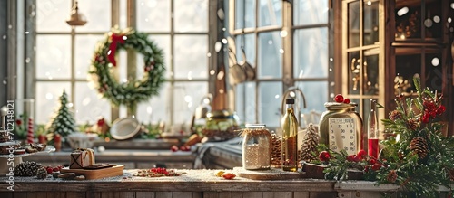 Christmas Kitchen Interior Ornamented Xmas Wreath with Beautiful Bow knot Pine Tree Branch near Window with Curtains Utensil Calendar Glass Bottles with Candies and Cookies on Wooden Furniture