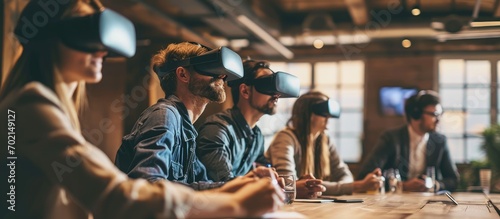 Business team using virtual reality headset in office meeting Developers meeting with virtual reality simulator around table in creative office. with copy space image. Place for adding text or design photo