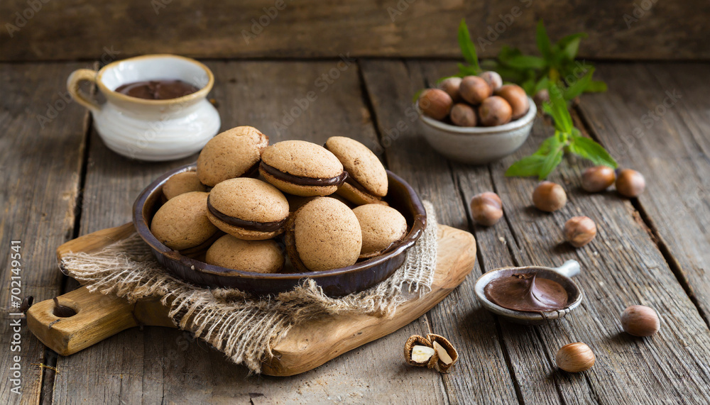 Baci di dama italian hazelnut biscuits cookies with chocolate cream, rustic style Baci di dama italian hazelnut biscuits cookies with chocolate cream, rustic style
