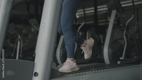 Woman running on treadmill in gym, Cycling at the Gym, Cardio and leg muscle, Building Leg Strength, Exercise for health, Warm up in the gym.