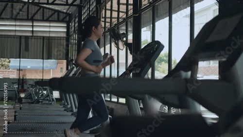 Woman running on treadmill in gym, Cycling at the Gym, Cardio and leg muscle, Building Leg Strength, Exercise for health, Warm up in the gym.