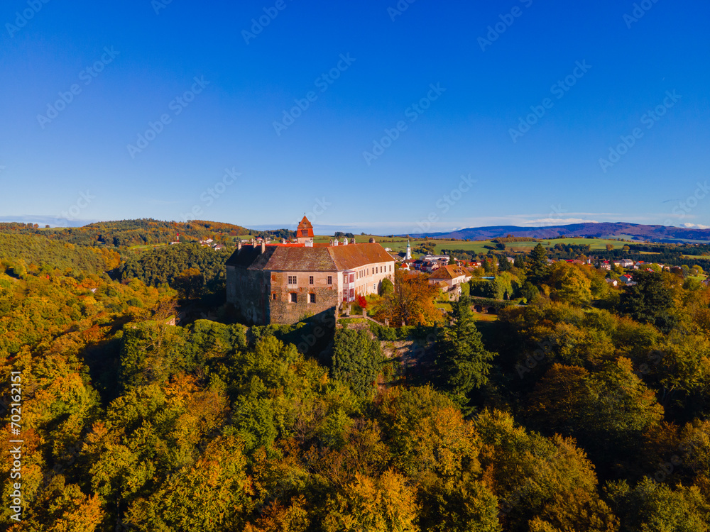 Ancient castle in fall forest colors.