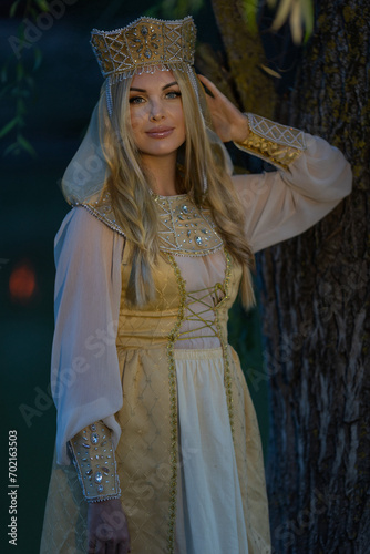 A beautiful Russian girl in a kokoshnik (crown). She has a Pavloposad shawl on her shoulders. Russian style, folk, retro, ethno. Selective focus photo