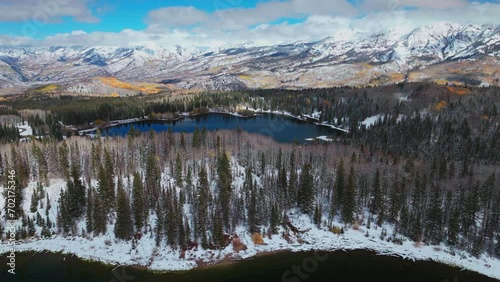 Lost Lake Kebler Pass aerial cinematic drone Crested Butte Gunnison Colorado seasons collide early fall aspen tree red yellow orange forest winter first snow powder Rocky Mountains forward slowly photo