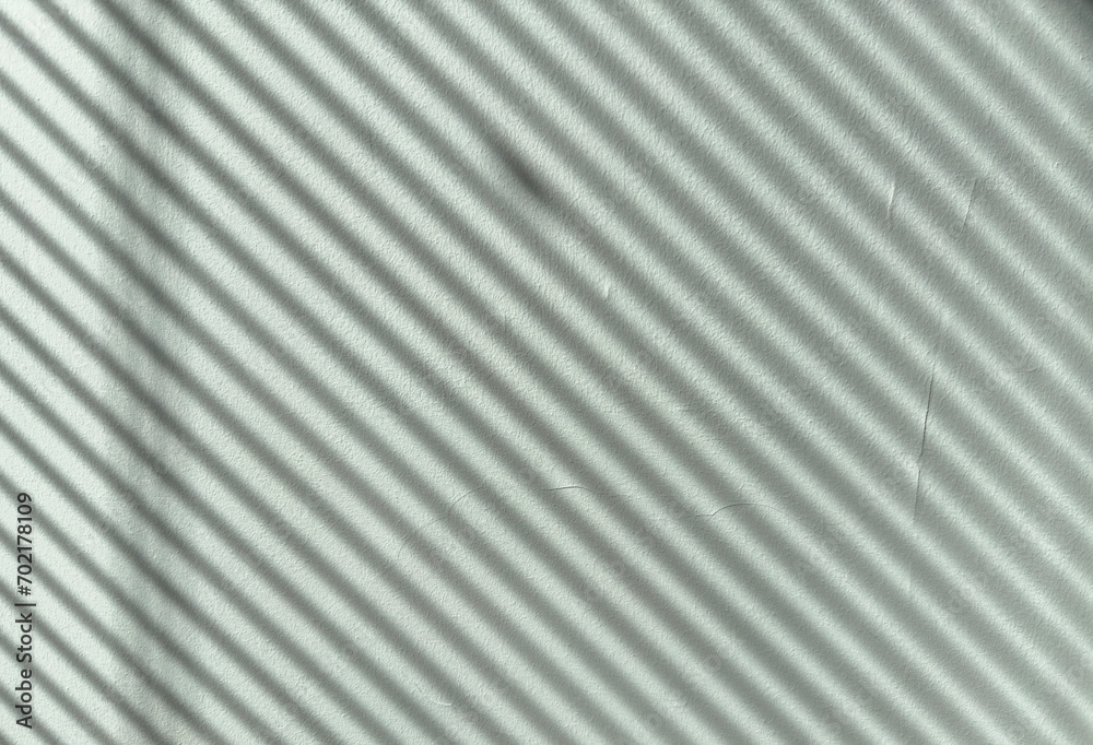 Shadows on wall. Abstract light, black shadow overlay from window shade on mint green wall