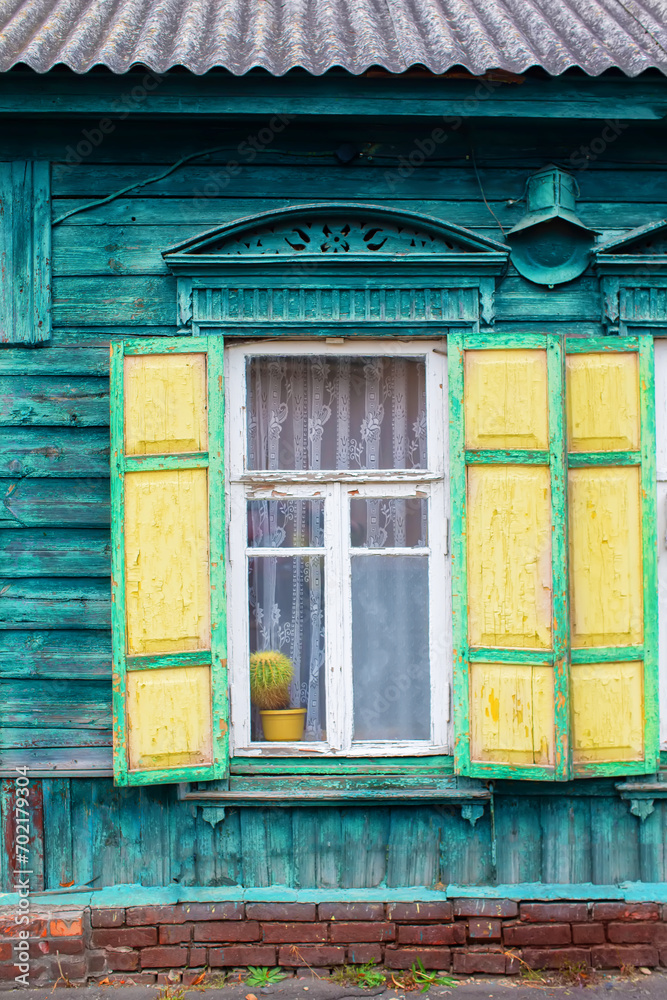 Background of an old window with wooden shutters. Wall of a wooden house with a window.