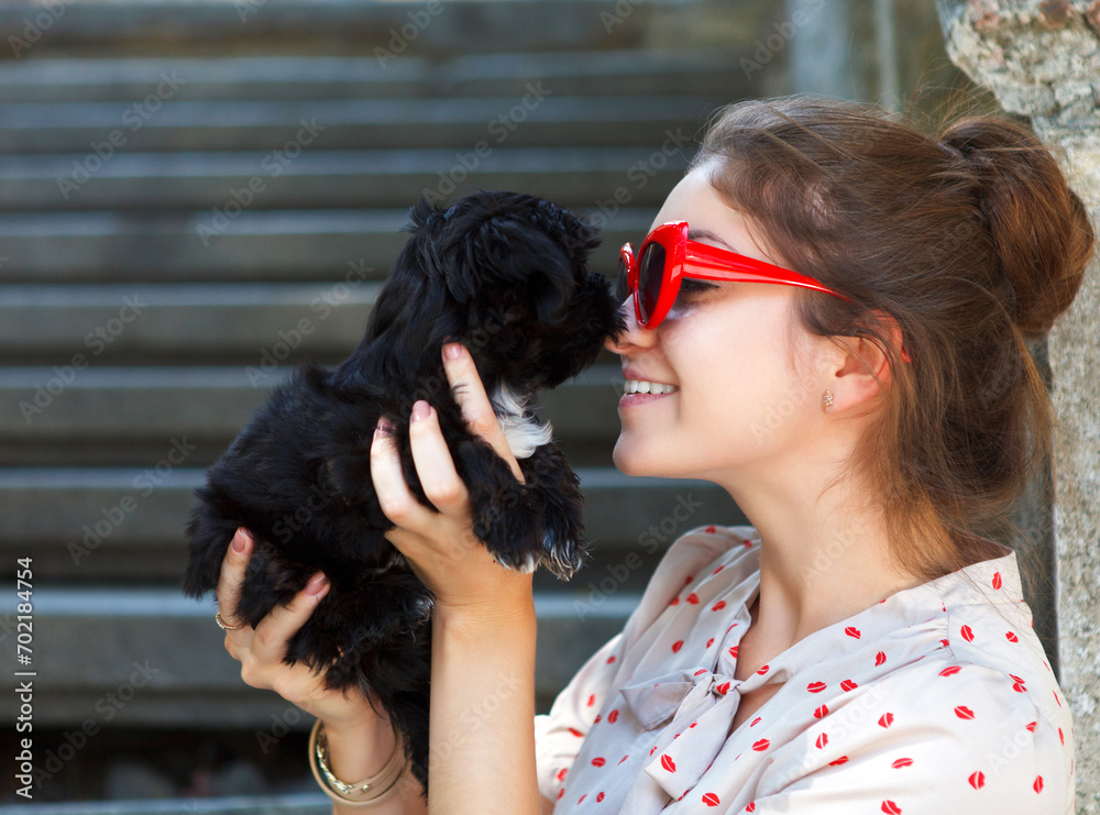 Young brunette woman hugging her lap dog puppy Young brunette woman hugging her lap dog puppy