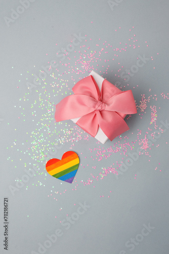 Stylish luxury gift box with rainbow LGBT heart on a light gray table. Homosexual and lgbt concept of holiday, birthday, valentine day, banner, flyer, innvitation