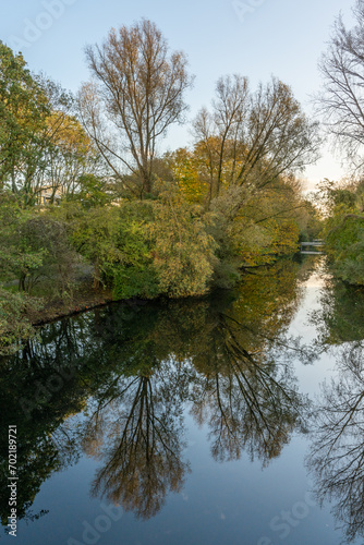 Gijsbrecht van Amstelpark with trees reflecting in water in Amsterdam, The Netherlands
