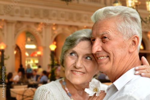old couple posing on blurred casino background