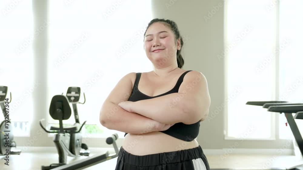 Portrait of overweight women cross her arms smiling and thumb up with a good positive to start exercise and gym. Portrait of overweight women cross her arms smiling and thumb up with a good positive to start exercise and gym.