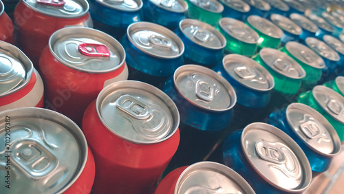 Rows of colorful metal cans with soda drink in shop