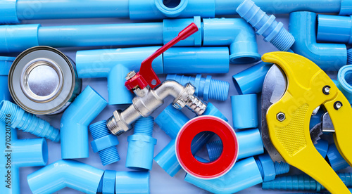 Plumber equipment with blue pvc pipe connections for plumbing work. photo