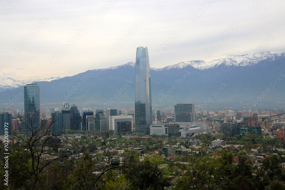 Fototapeta premium Panoramic view of the Chilean capital Santiago de Chile with the Gran Torre Santiago skyscraper and the Andes in the background