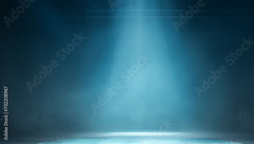 Blue theatrical beams of overhead light illuminating an empty dark stage. Bright neon spotlights and smoke on a black studio background. Light show, disco club lights. photo