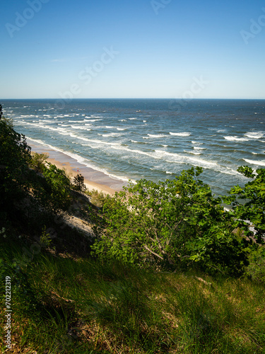 Aerial view of stormy Baltic sea with waves and beach with blue sky - copy space
