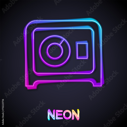 Glowing neon line Safe icon isolated on black background. The door safe a bank vault with a combination lock. Reliable Data Protection.  Vector