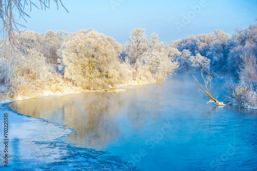 Witness the breathtaking beauty of the frozen river at sunrise. Enjoy the mesmerizing spectacle of shimmering frost. Awaken your senses to the splendor of the frozen beauty of winter.