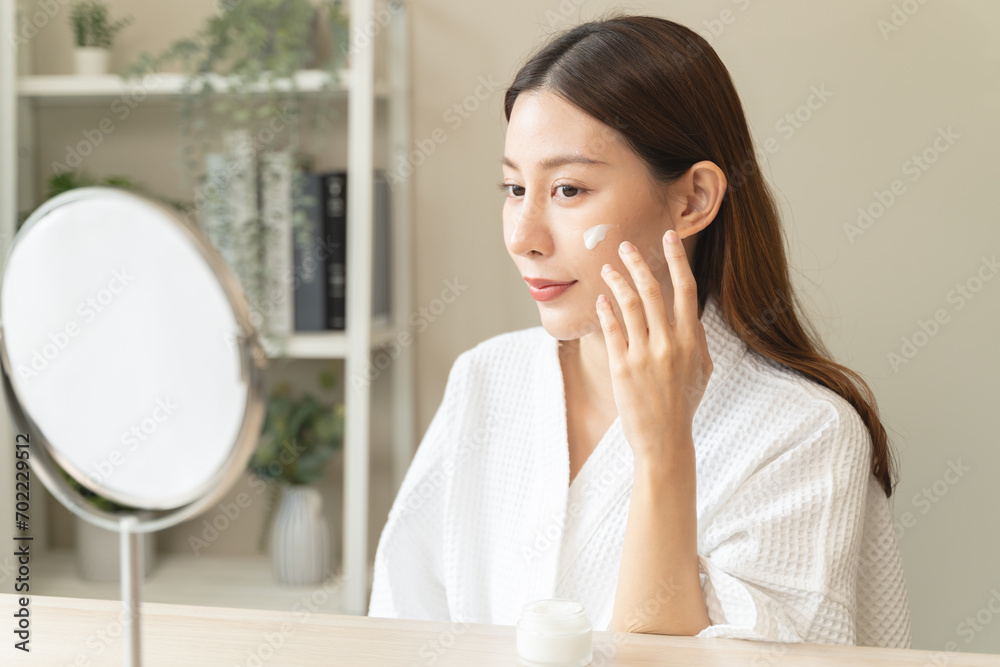 Effortless Elegance: A Serene Moment of Self-Care as a Woman Applies Luxurious Moisturizing Cream for Glowing, Nourished Skin and Unveils the Beauty of Skincare Rituals Effortless Elegance: A Serene Moment of Self-Care as a Woman Applies Luxurious Moisturizing Cream for Glowing, Nourished Skin and Unveils the Beauty of Skincare Rituals