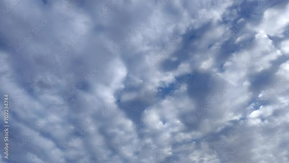 Large altocumulus clouds circulate through the radiant sky Large altocumulus clouds circulate through the radiant sky