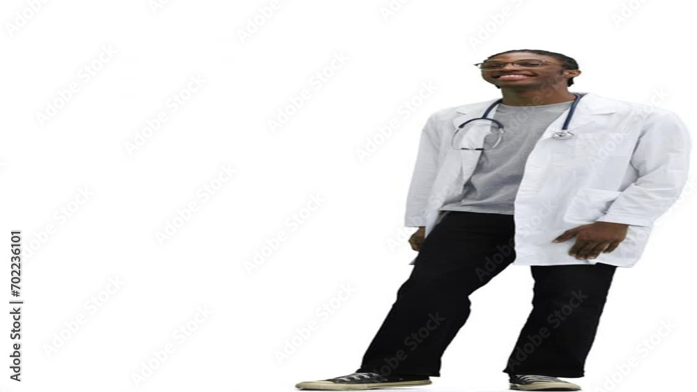 The male doctor, on a white background, in full height, points to the side