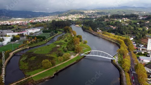 inematic aerial perspective of Pontevedra city. Drone going backwards ascending revealing the beautiful landscape. Famous travel destination in Galicia. River Lerez and Ponte da Illa do Covo photo