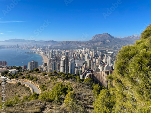 Stunning view from above of the famous Benidorm resort town with skyscrapers buildings, mountains and mediterranean sea on a sunny day