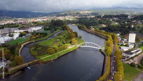 Cinematic aerial perspective of Pontevedra city. Drone going forward revealing the beautiful landscape. Famous travel destination in Galicia. River Lerez and Ponte da Illa do Covo photo