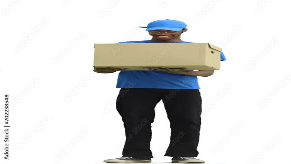 A male courier, on a white background, in full height, catches a box