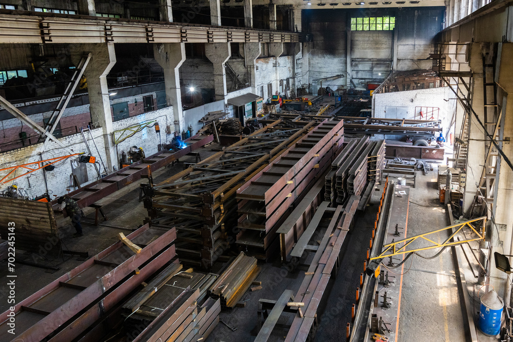 Kyiv, Ukraine - 15.06.2022: Various metal structures cut in the workshop. The factory produces metal parts, elements, and structures. Plant for the production of metal structures. Kyiv, Ukraine - 15.06.2022: Various metal structures cut in the workshop. The factory produces metal parts, elements, and structures. Plant for the production of metal structures.