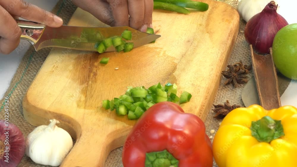 Cutting Fresh Bell Peppers on Top of Wooden Board Cutting Fresh Bell Peppers on Top of Wooden Board