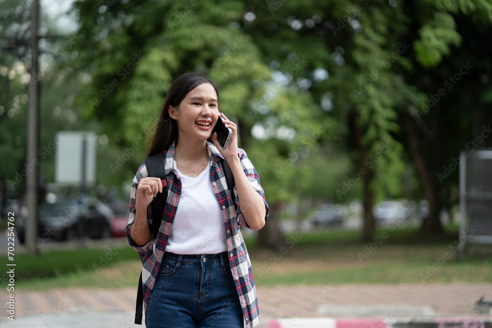 Students walk on campus and use their phones to contact friends