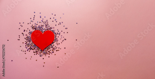 Pink pastel background with small hearts confetti. Flatlay, top view, copy space