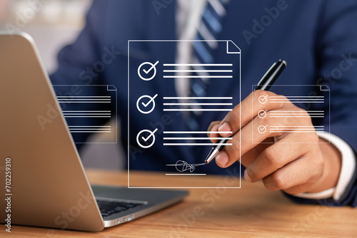 Efficient Electronic Signature Concept, Businessman using stylus pen signs electronic documents on digital documents on virtual tablet. Signing electronic documents for paperless transactions.