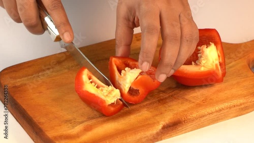 Women Cutting Stuffed Bell Peppers on a Wooden  Board